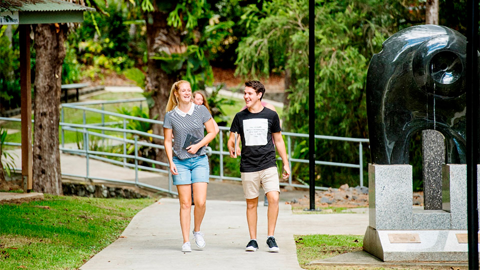 Two students walking on path at Lismore campus