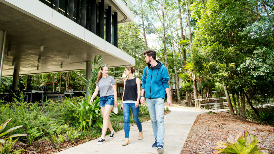 Three students walking outside the Learning Centre, Lismore campus